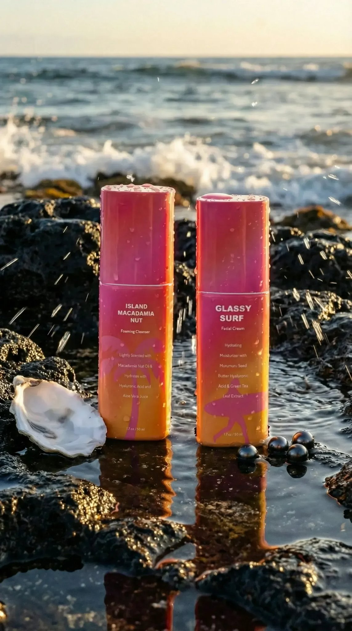 Island Macadamia Nut Foaming Cleanser and Glassy Surf cream standing on ocean rocks with white bottle seam lines